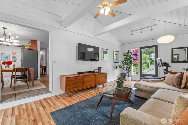 Spacious second living room with vaulted ceilings and free-standing wood-fired stove. New LVP flooring!