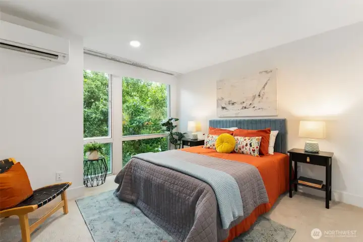 Dreamy top floor primary suite - floor to ceiling windows, walk-in closet, ensuite bath.