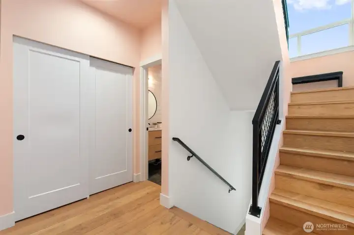 Stairway to the ground floor, and a full bath to the left.