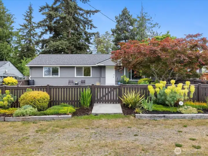Welcome home to this comfortable home with its beautifully landscaped, fenced front yard.