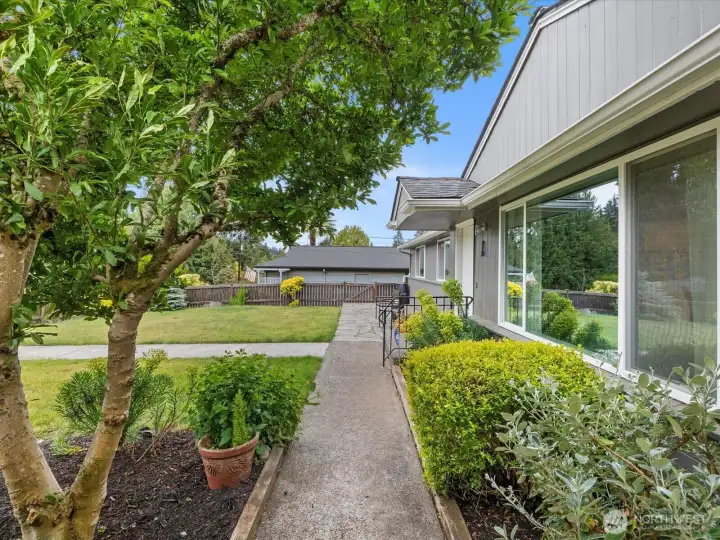 The front walkways from the street and the large carport.