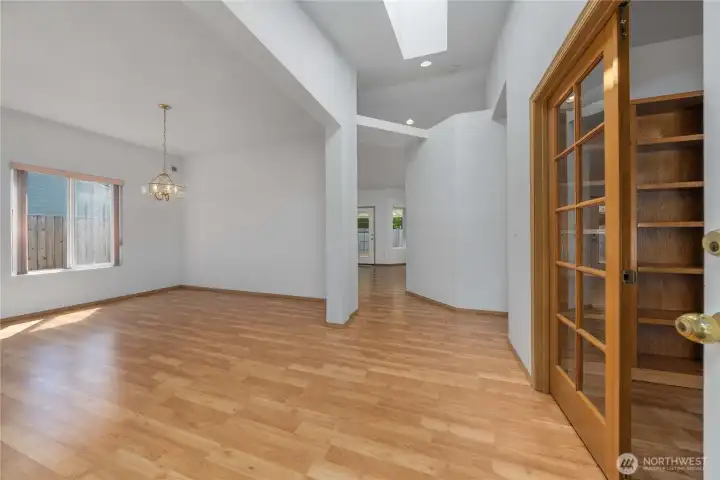 Upon entry, you're greeted by a warm and welcoming space with vaulted ceilings and 3rd bedroom or den off to right. Notice french glass doors.