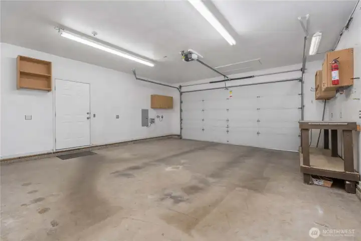 The garage is spacious and well lit with more workshop space.
