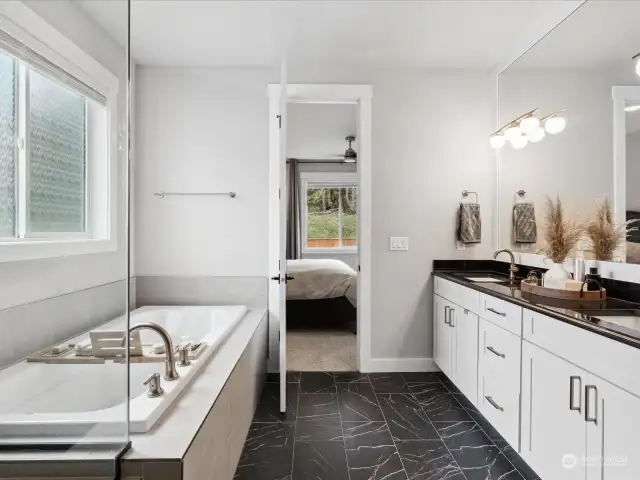 Extra long soaking tub is the perfect spot to relax and unwind after a long day.