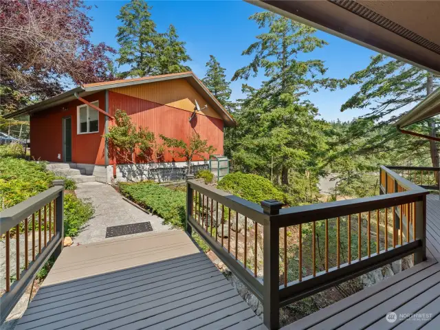 There is a bridge that crosses over the rocks from the first floor to the garage and parking.