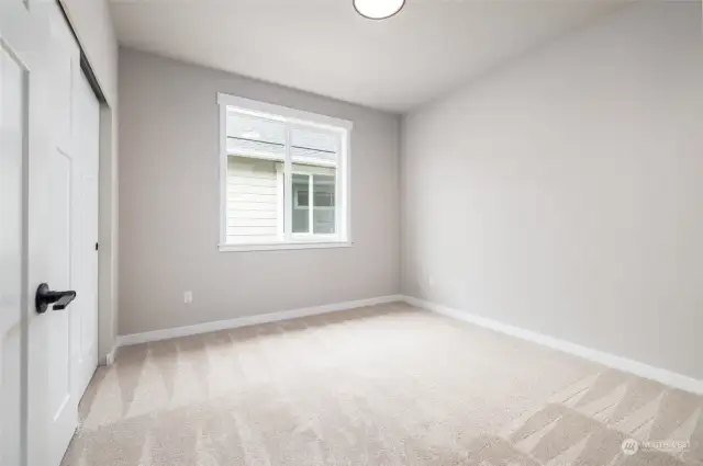 Bedroom 2  The house is built w/9' ceilings, taller windows and painted millwork to keep it light and bright.