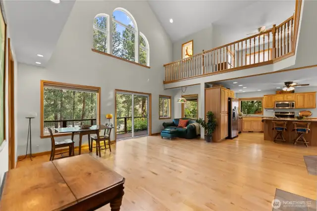 Maple hardwood floors link the open floor plan to a sitting area with wood stove.