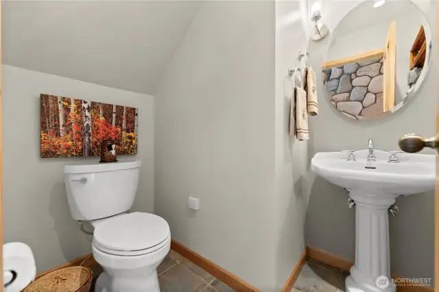 Main floor guest powder room/bathroom off foyer.