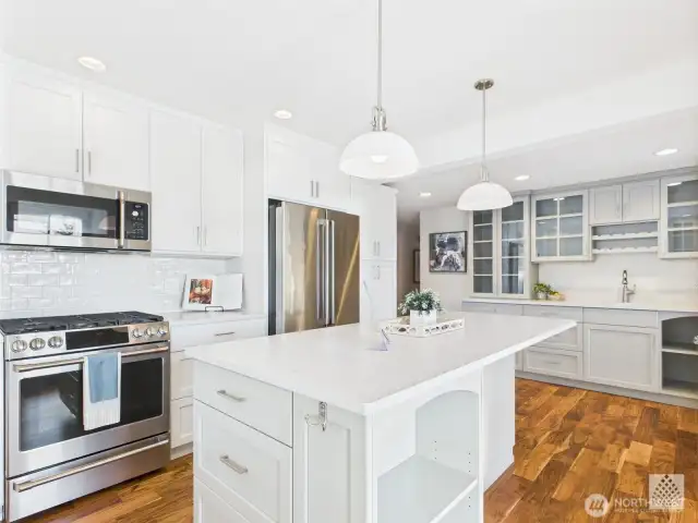 An elegant wet bar and custom wine area adds a touch of luxury, making this kitchen ideal for entertaining guests.