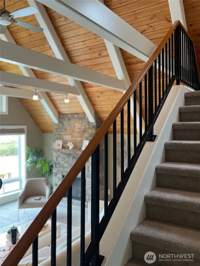 Custom iron railing that leads up to the loft with a sitting area and 3rd bedroom.
