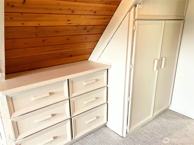 Upstairs bedroom with original built-ins and extra storage.