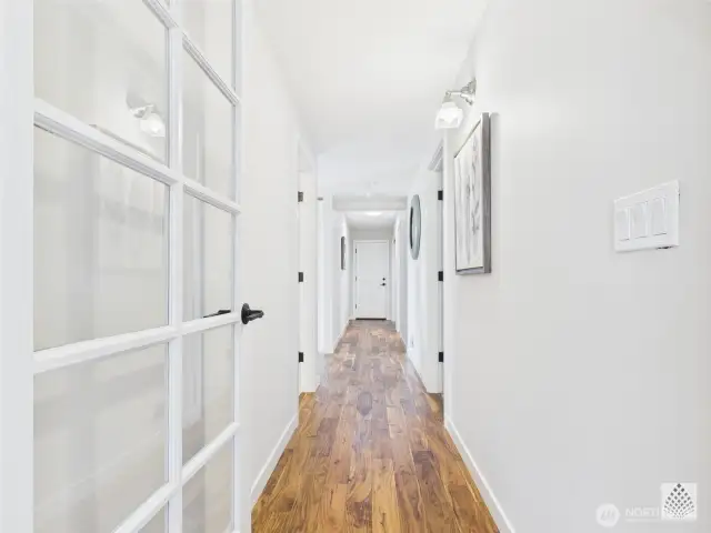 Beautiful hardwood floors line the main-floor hallway, which effortlessly connects the garage, bedrooms, bathroom, office and kitchen for easy everyday living.