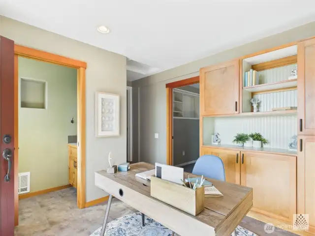 In addition to serving as a second entrance, this custom flex space connects seamlessly to the half bathroom, office, and hallway providing a practical and versatile link to the rest of the home.