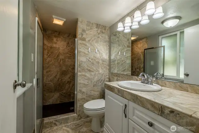 primary bathroom with walk in shower and bench