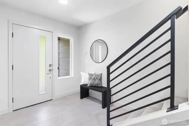 Covered entry on ground level opens to bright foyer with durable tiled floor.
