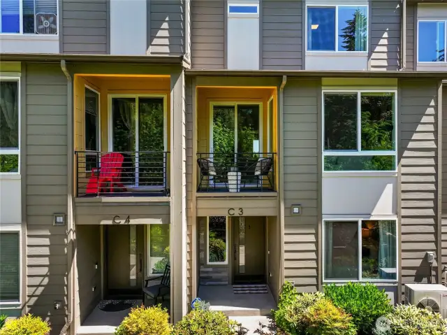Covered balcony and front entry face the greenbelt.