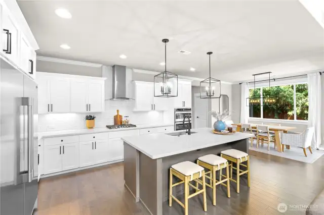 Spacious kitchen with stainless steel appliances and oversized island