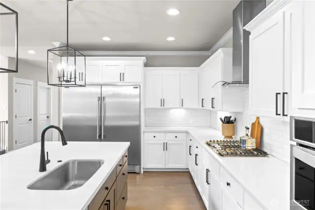 Custom cabinets with under cabinet lighting, soft close feature and upgraded hardware and upgraded quartz countertops