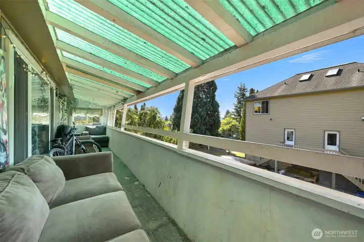 Deck off the living room of the house.  Duplex on the right