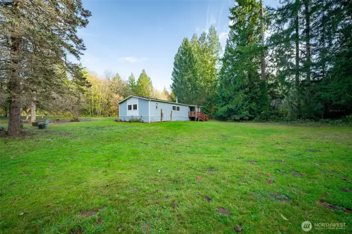 The back deck off the house leads to the large backyard.