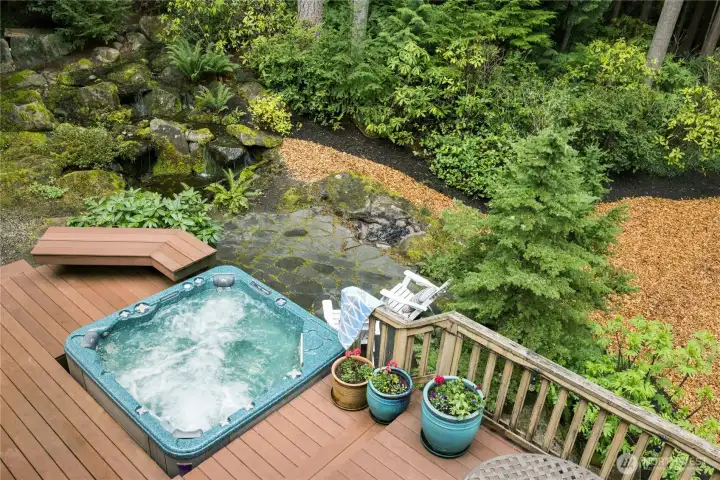 Looking down from the primary bedroom, you can check out your waterfall pond, hot tub and fire-pit slate patio Looking down from the primary bedroom, you can check out your waterfall pond, hot tub and fire-pit slate patio