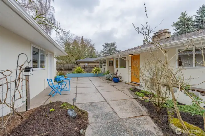 Welcoming courtyard entrance connects garden, garage and house.  Full sunshine will bring out the best in all your plants from this lovely space.