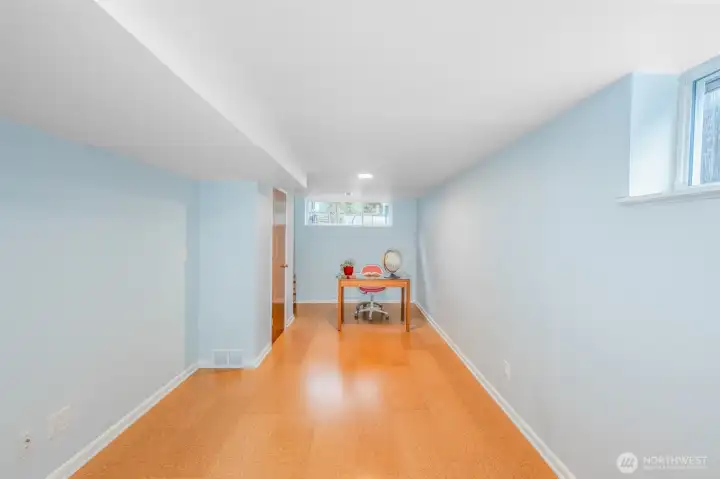 Lower bedroom with cork flooring.