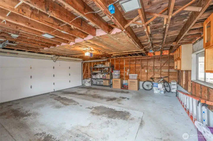 Two car garage has a permitted sub-panel.