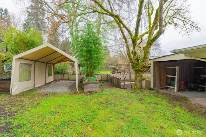 Side parking for RV, boat + carport is there, currently used for garden supplies.