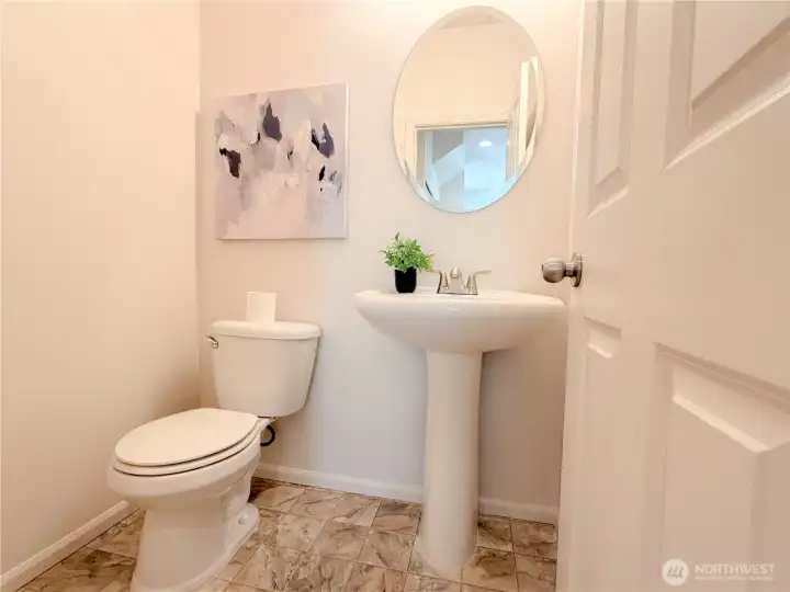 Cute half bath is downstairs as you come in from the garage