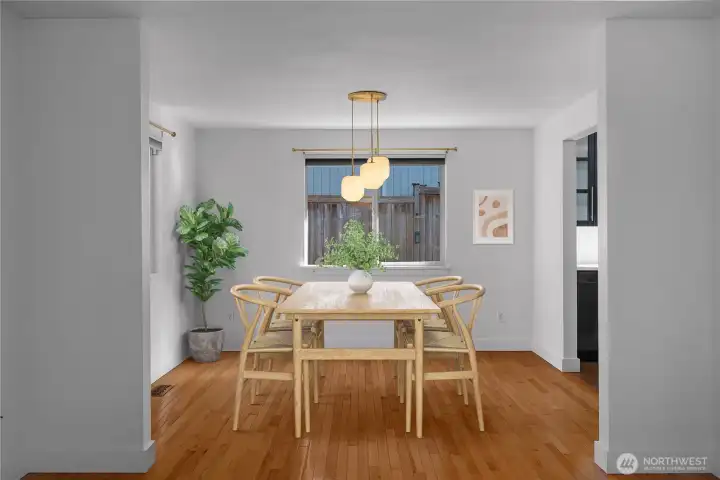 The virtually staged dining area highlights the home’s light-filled, airy ambiance.