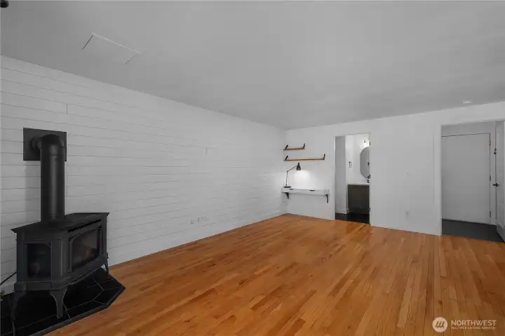 Shiplap wall, corner shelving and gas stove elevate the family room.