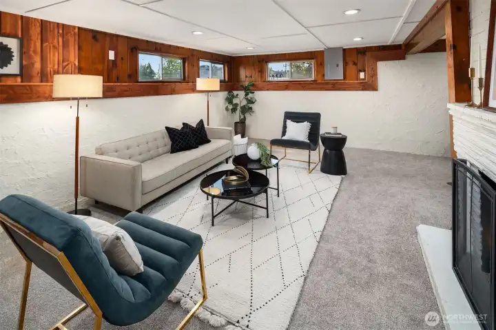 Lower floor living room with fireplace and new carpet