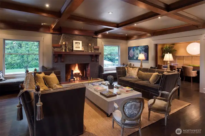 plush window seats, mohair and leather Knole style sofas cozy up to the original fireplace and custom concrete table by notable local designer, Rocky Rochon.