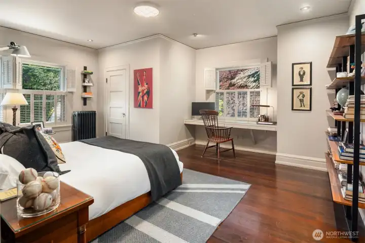 Northeast bedroom with walk in closet and built in desk.
