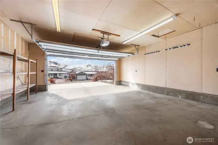Oversized 2 car garage with door to patio in fenced back yard.