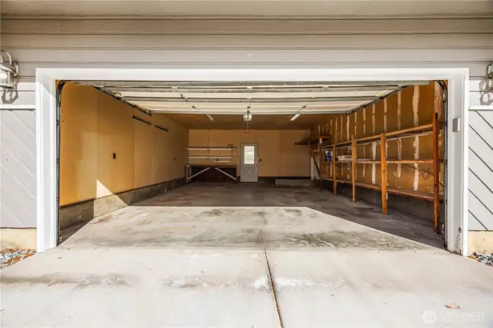 Oversized 2 car garage with door to patio in fenced back yard.