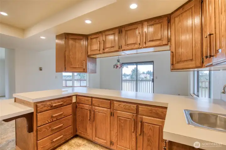 Full view of the cabinets toward the dining room noting the window views of Duck Lake! Full view of the cabinets toward the dining room noting the window views of Duck Lake!
