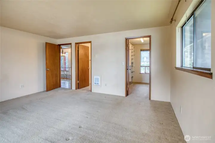 View of the primary bedroom to the walk-in closet on the right and full bath ensuite on the left! View of the primary bedroom to the walk-in closet on the right and full bath ensuite on the left!