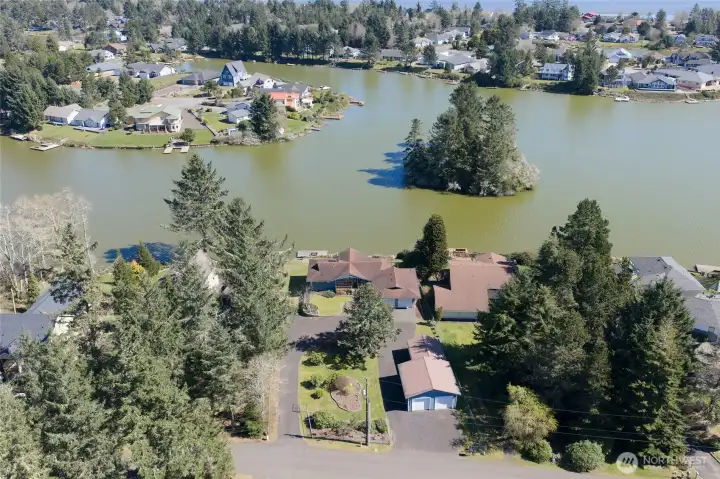 Drone view of the home and property shows the paved semi-circular driveway which offers easy access to the home and plenty of parking! Drone view of the home and property shows the paved semi-circular driveway which offers easy access to the home and plenty of parking!