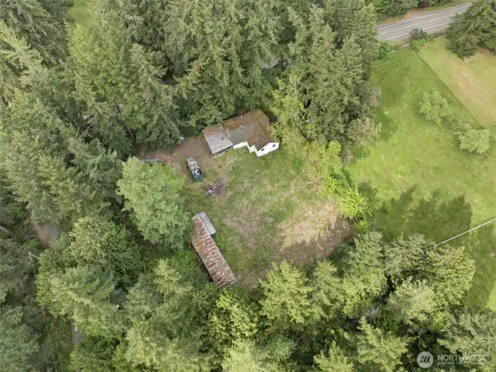 Drone showing both dwellings and surrounds woods.
