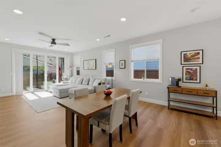 Dinner with a view! The dining area sits just steps from the massive sliding glass door, leading you directly out to the covered patio and outdoor living space.