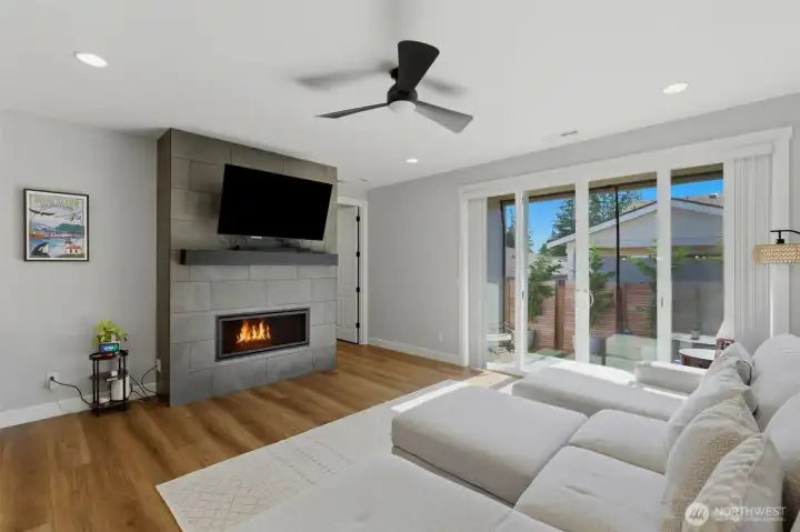 The ultimate spot to unwind. Cozy up by the elegant fireplace on chilly winter nights, surrounded by soaring ceilings and an abundance of natural light.