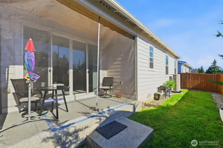 A perfect view of your outdoor living space. See how beautifully the covered patio blends into the yard, making it the ultimate spot for summer barbecues and weekend lounging.