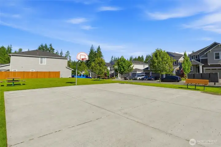 Stay active right at home! Enjoy great neighborhood perks like this well-maintained basketball court and the nearby parks and picnic tables.