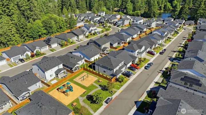 Welcome to the heart of the community! This aerial perspective showcases the fantastic neighborhood parks and picnic spaces right at your doorstep, offering the perfect spot to meet neighbors or enjoy a sunny afternoon.
