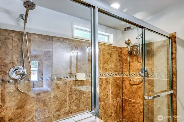 Primary shower with rain shower head and dual hand wandsd