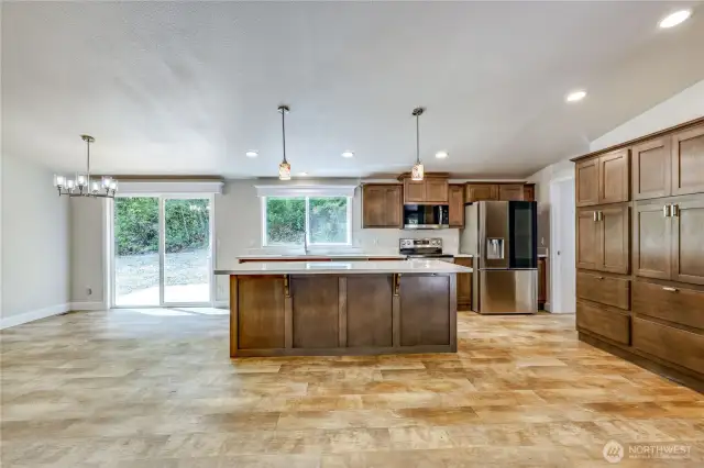 Large kitchen with quartz countertop, island