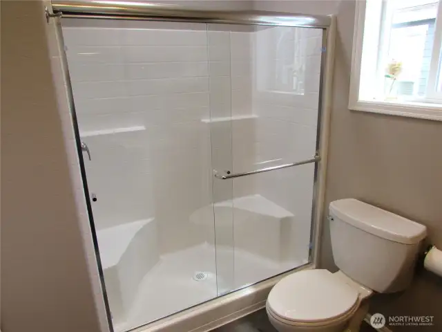 FULL-SIZED WALK IN SHOWER, BUILD IN SEATING, COMES WITH NEW SHOWER DOORS.
