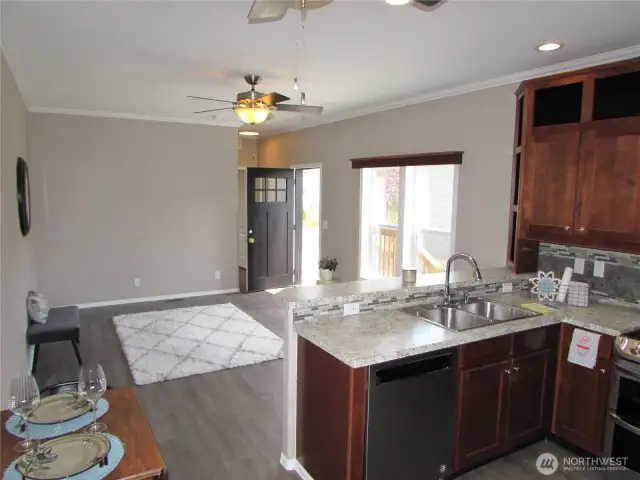 LIVING ROOM WINDOWS FACE SOUTH AND HEAT PUMP TO KEEP YOU COOL.